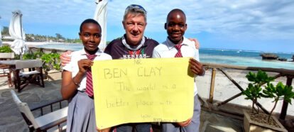 Ben and two students with a lovely large written thank you note