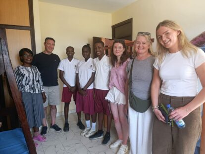 Visitors from the UK, Lucy and family, in one of the safehouse rooms with three of the kids and the girls' housemother