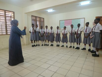 A female engineer talks to a group of girls about engineering as a career