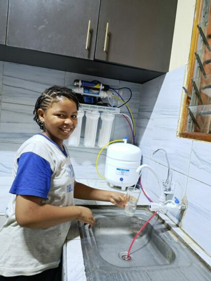 Young student at the Bombolulu school tests the new water purifier