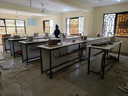 A worker putting some of the finishing touches to the science lab