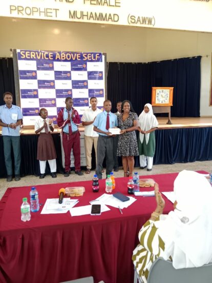 A Bombolulu Educational Centre student receives an award at the recent debating contest