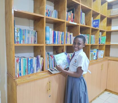 Young female student with a book in the newly finished library
