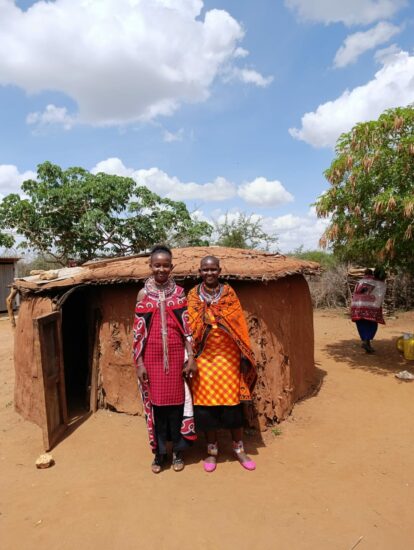 Our Masai pupil Rina in front of her home