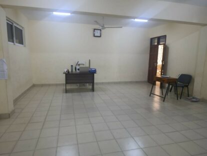One of the classrooms showing just a teacher's desk, there is more work to be done