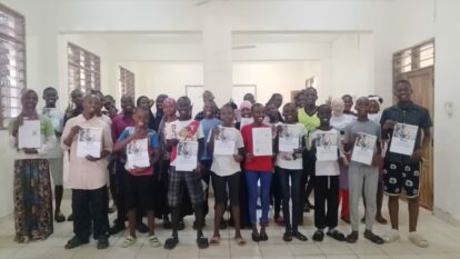 The students showing their YESS graduation certificates
